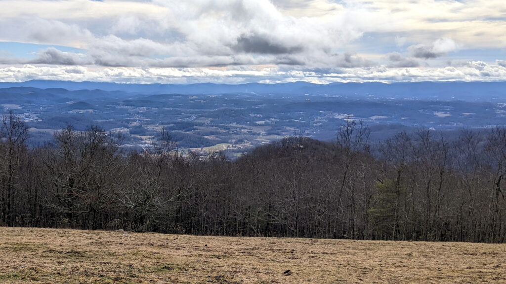 A landscape on the top of a mountain in December outside Asheville, North Carolina where you can see the Blue Ridge Mountains in the distance. Live life in full color!
