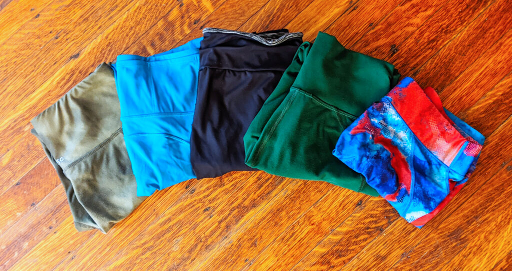 folded workout leggings sitting on the floor, ready for spring cleaning, fitness style