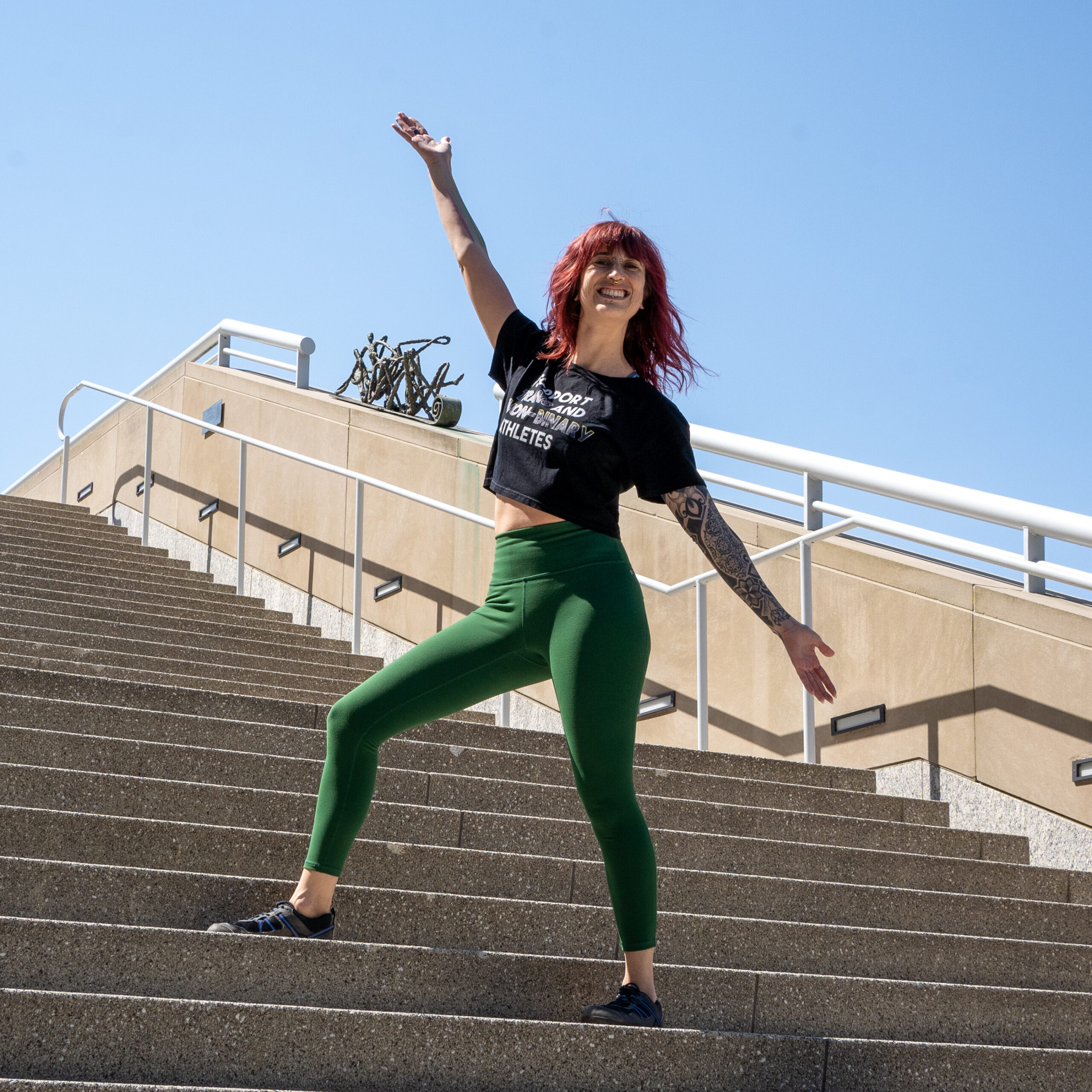 Sarah celebrating on steps after creating fitness goals and reaching them