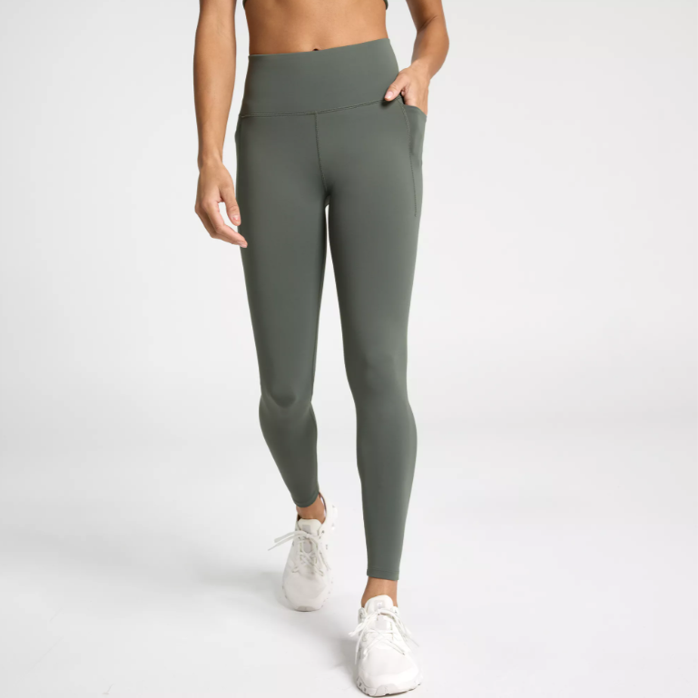a woman wearing a pair of grey-green workout leggings with pockets