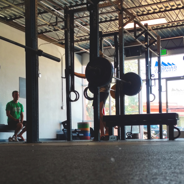 a gym with barbells and benches