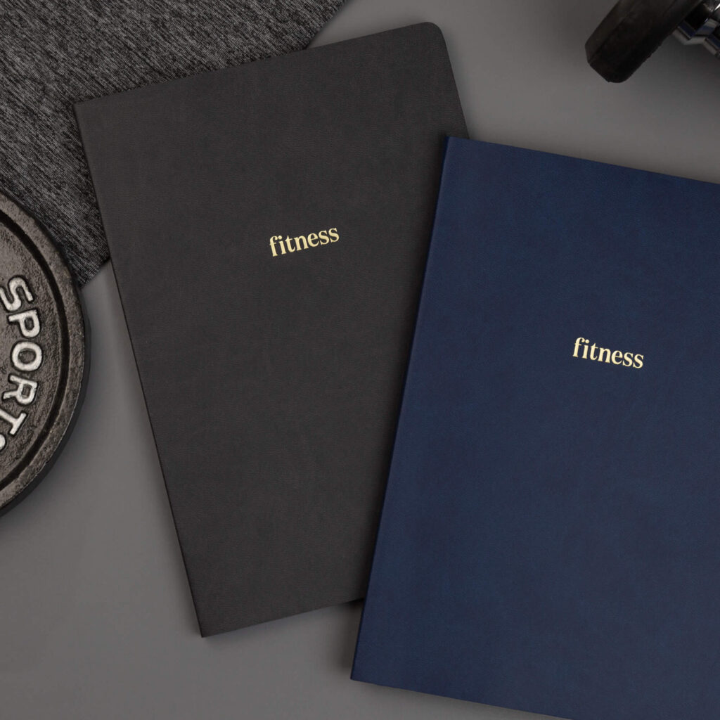 two fitness planners, one dark grey and one navy